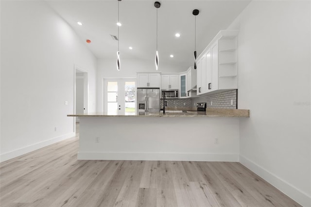 kitchen with stainless steel appliances, light hardwood / wood-style floors, kitchen peninsula, decorative light fixtures, and white cabinets