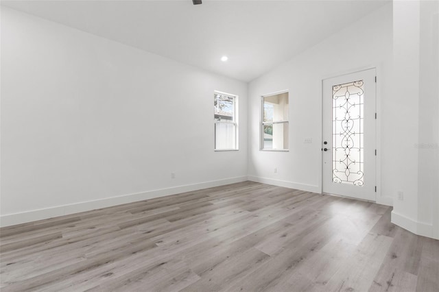 foyer featuring light hardwood / wood-style floors and vaulted ceiling