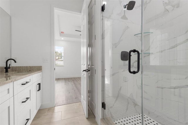 bathroom featuring wood-type flooring, vanity, and a shower with door