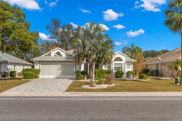 ranch-style house with a front yard, central AC, and a garage