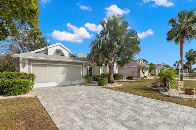 ranch-style house featuring a front lawn and a garage