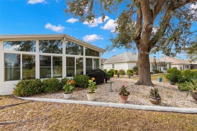 view of side of home with a sunroom