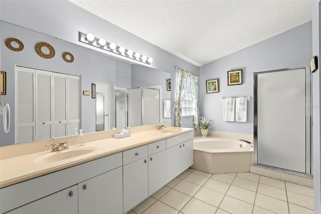 bathroom featuring plus walk in shower, a textured ceiling, tile patterned floors, lofted ceiling, and vanity