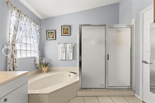 bathroom featuring vanity, a textured ceiling, lofted ceiling, and separate shower and tub