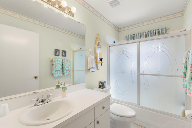 full bathroom featuring vanity, shower / bath combination with glass door, and toilet