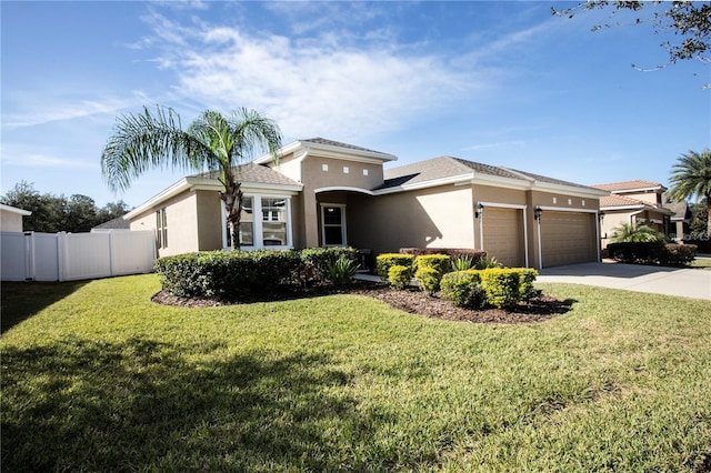 view of front of house with a front yard and a garage