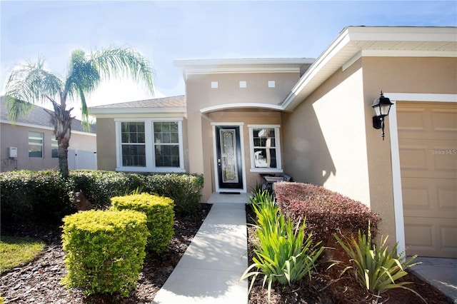 view of exterior entry featuring a garage