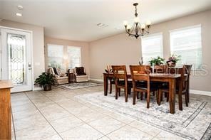 tiled dining space featuring a notable chandelier