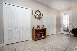 entryway with light tile patterned floors