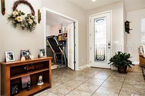 entryway with light tile patterned floors