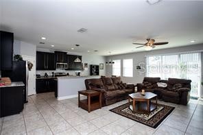 living room featuring ceiling fan and light tile patterned floors