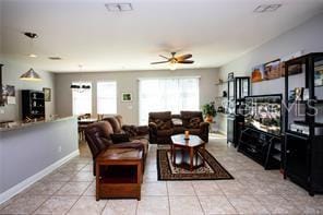 living room featuring ceiling fan and light tile patterned floors