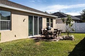 rear view of house with a lawn