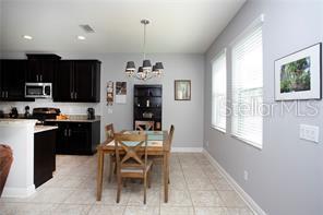 kitchen with plenty of natural light, hanging light fixtures, a notable chandelier, and light tile patterned flooring