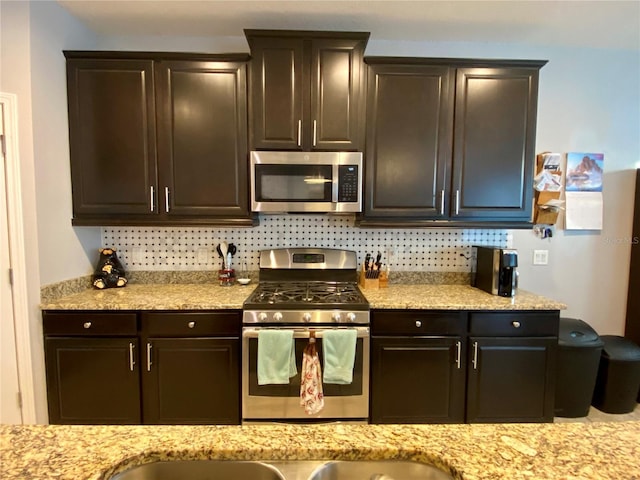 kitchen with tasteful backsplash, dark brown cabinets, and appliances with stainless steel finishes