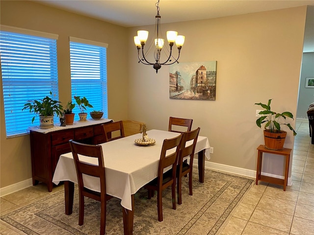 tiled dining room featuring a chandelier