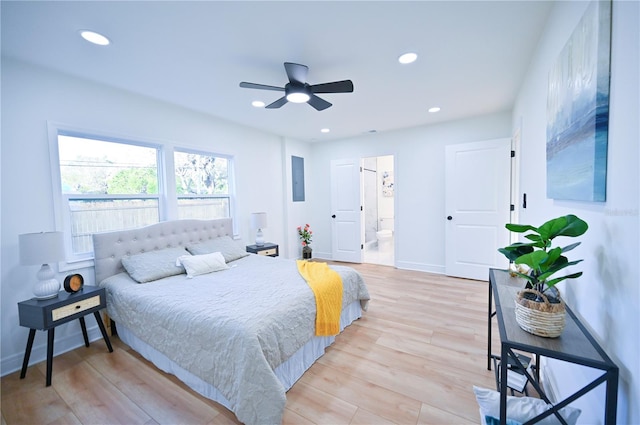 bedroom with connected bathroom, light hardwood / wood-style flooring, and ceiling fan