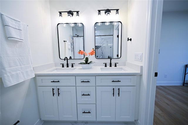 bathroom featuring vanity, hardwood / wood-style flooring, and walk in shower