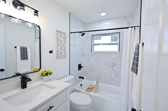 full bathroom with vanity, shower / bath combination with curtain, and toilet