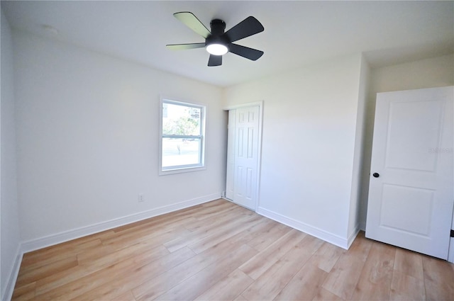 unfurnished bedroom with a closet, light wood-type flooring, and ceiling fan