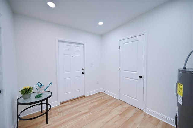 foyer featuring light hardwood / wood-style flooring and water heater