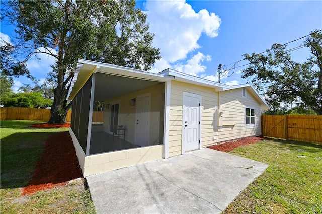 back of house featuring a yard and a patio