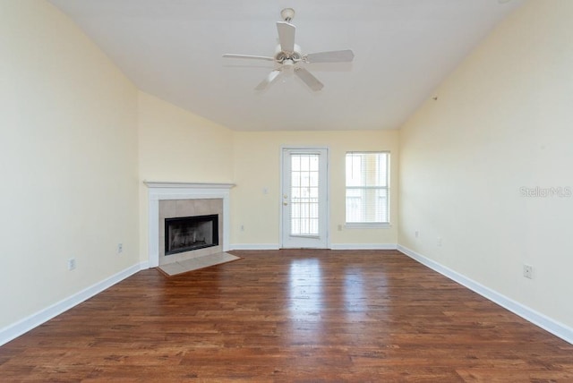 unfurnished living room featuring lofted ceiling, ceiling fan, a fireplace, and dark hardwood / wood-style flooring