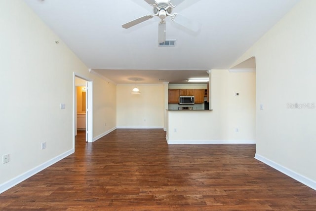 unfurnished living room featuring dark hardwood / wood-style floors and ceiling fan