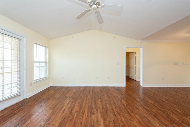 empty room with ornamental molding, dark wood-type flooring, vaulted ceiling, and ceiling fan