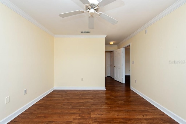 empty room with ornamental molding, dark wood-type flooring, and ceiling fan