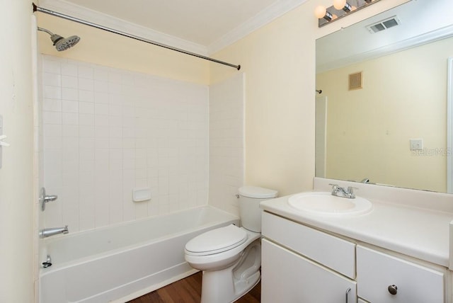 full bathroom featuring shower / washtub combination, hardwood / wood-style floors, toilet, ornamental molding, and vanity