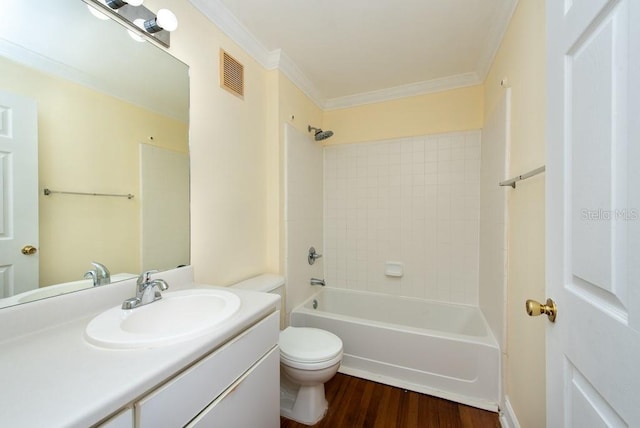 full bathroom featuring hardwood / wood-style flooring, toilet, ornamental molding, vanity, and tiled shower / bath combo