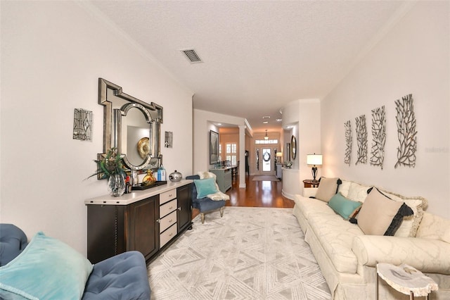 living room featuring light hardwood / wood-style floors and a textured ceiling