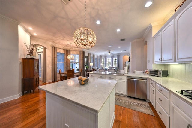 kitchen with a center island, ceiling fan with notable chandelier, stainless steel dishwasher, decorative light fixtures, and kitchen peninsula