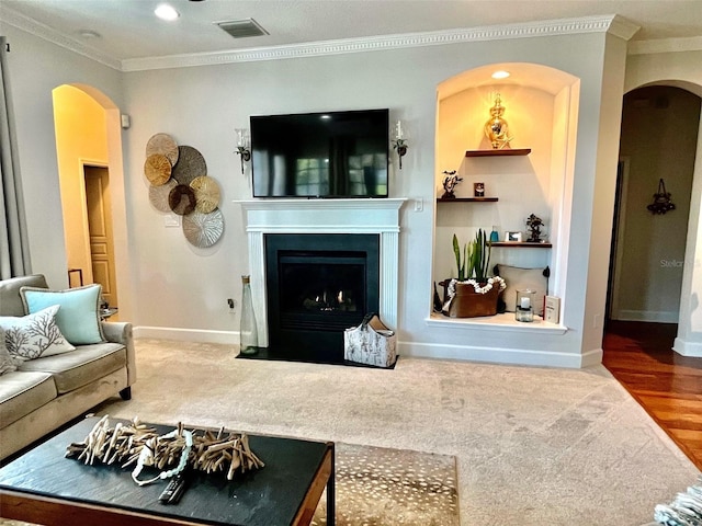 living room with hardwood / wood-style flooring and ornamental molding