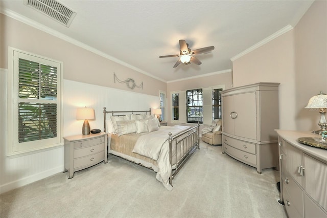 carpeted bedroom featuring ceiling fan and ornamental molding