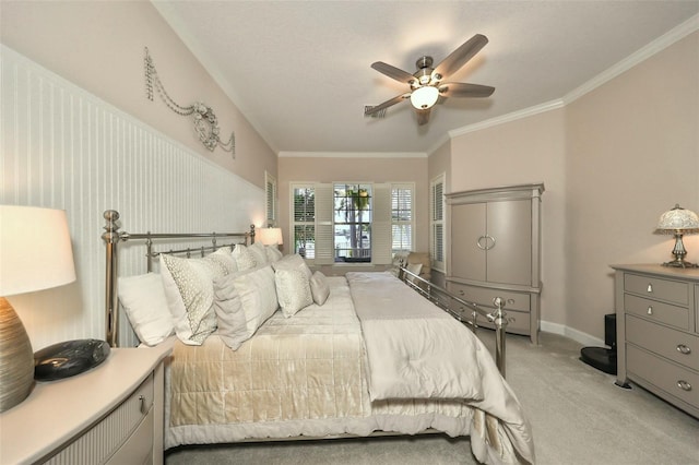 bedroom featuring light colored carpet, ceiling fan, and crown molding