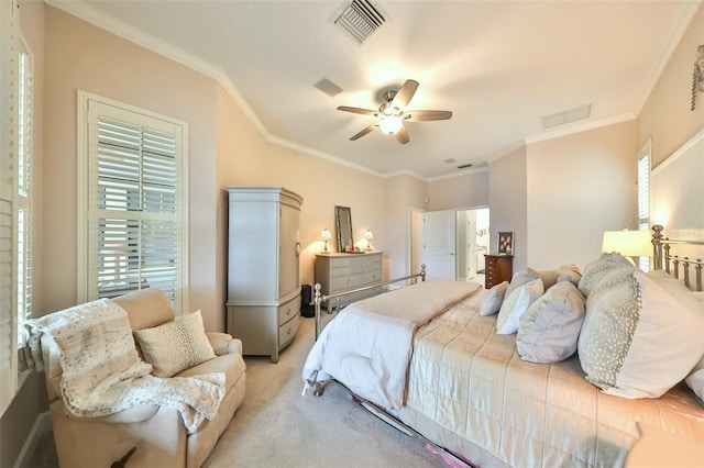 carpeted bedroom featuring ceiling fan and crown molding