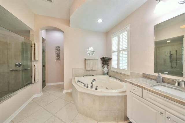 bathroom featuring tile patterned floors, vanity, and plus walk in shower