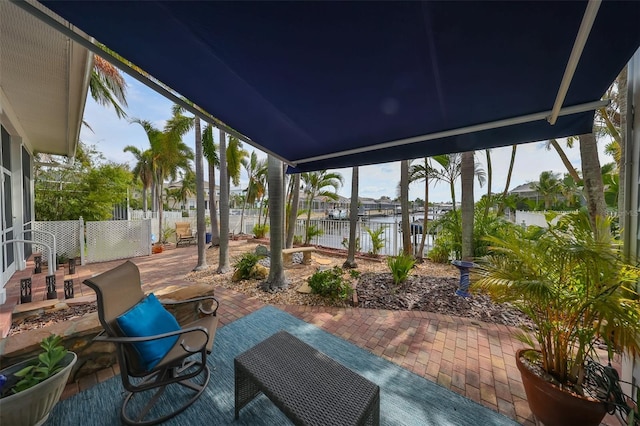 sunroom / solarium featuring a water view