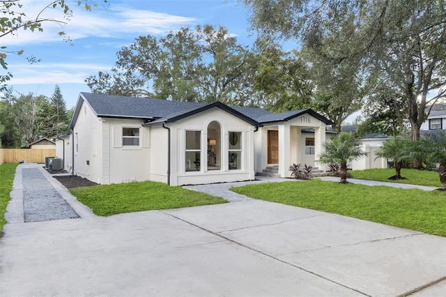 view of front of home featuring central AC and a front lawn