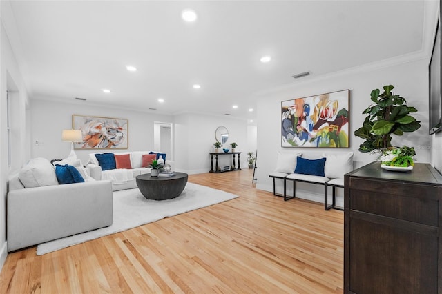 living room featuring ornamental molding and light wood-type flooring