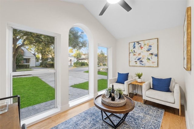 sitting room with ceiling fan, hardwood / wood-style floors, and lofted ceiling