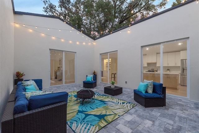 view of patio / terrace featuring an outdoor living space with a fire pit