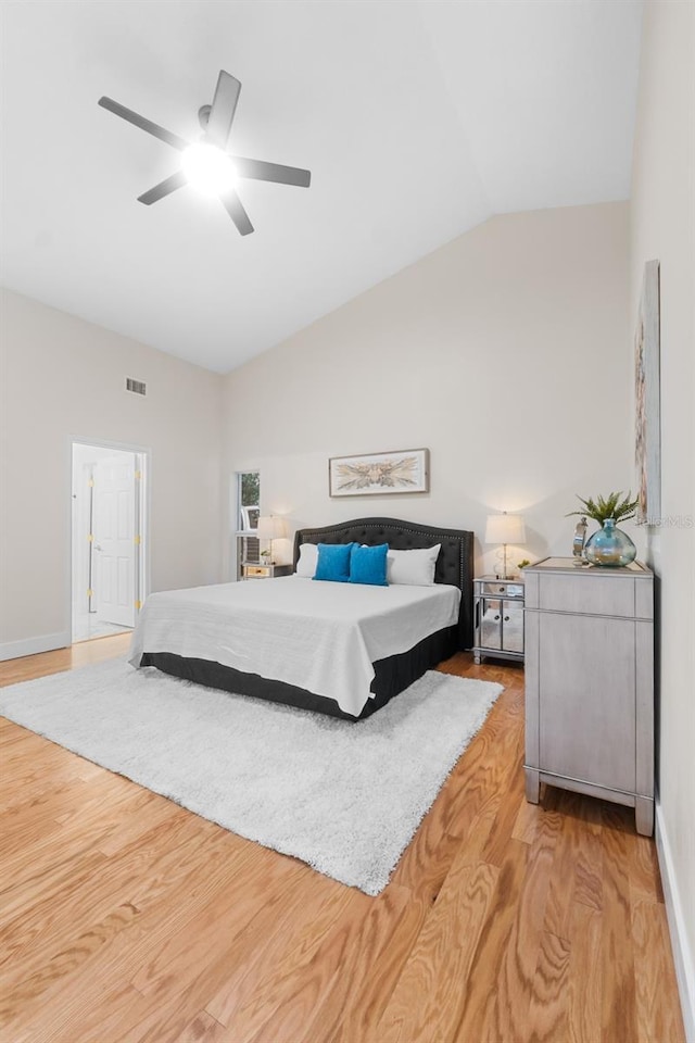 bedroom featuring ceiling fan, vaulted ceiling, and light wood-type flooring