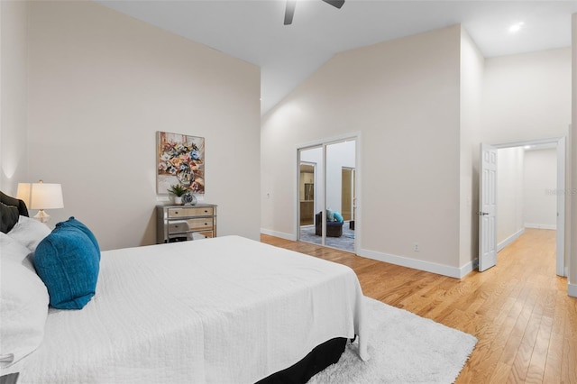 bedroom featuring hardwood / wood-style flooring, high vaulted ceiling, and ceiling fan