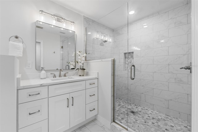 bathroom featuring vanity and an enclosed shower