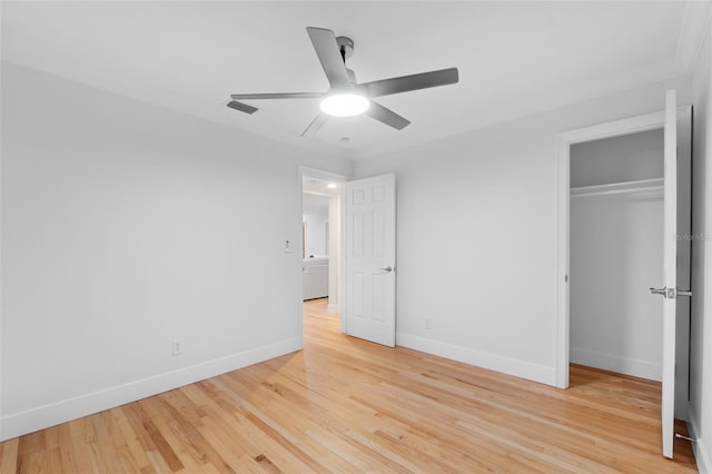 unfurnished bedroom featuring ceiling fan, light hardwood / wood-style floors, and a closet