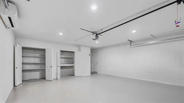 garage featuring a garage door opener and a wall mounted air conditioner