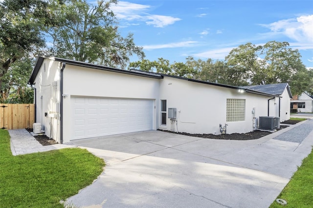 view of property exterior with central AC and a garage